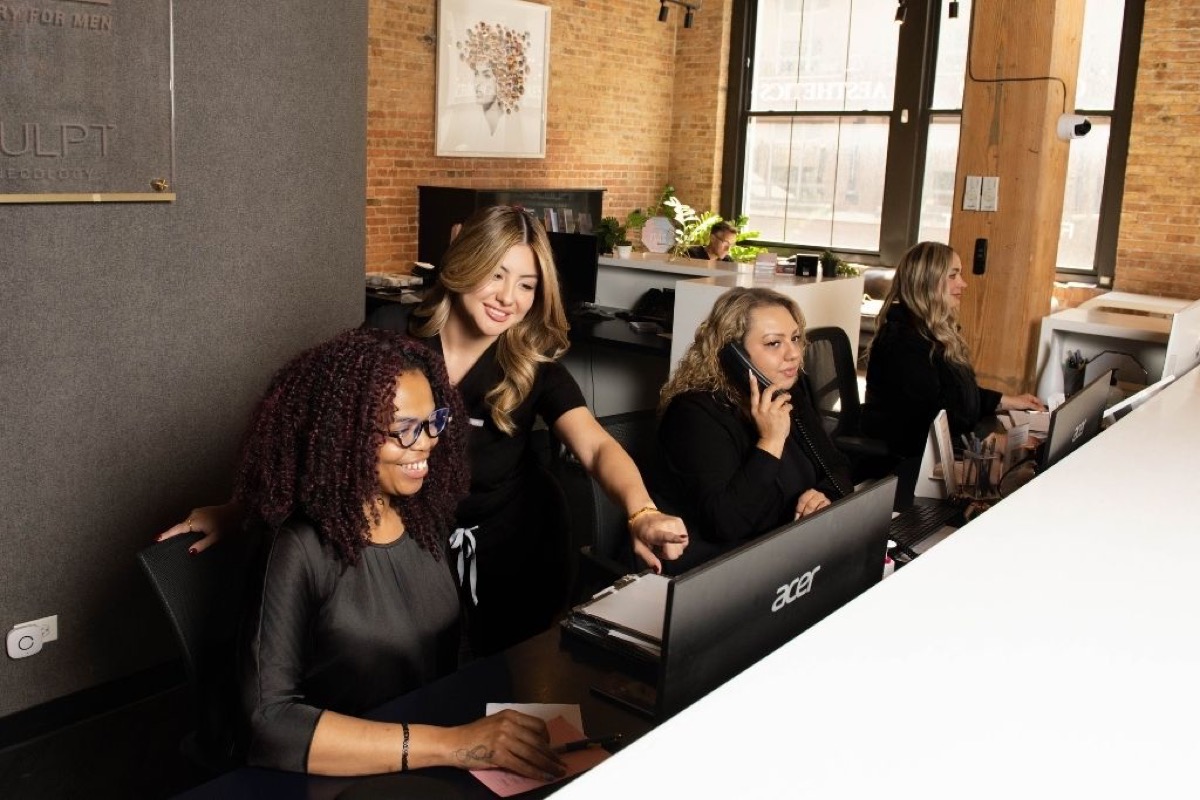 Patient coordinators at the front desk of the practice