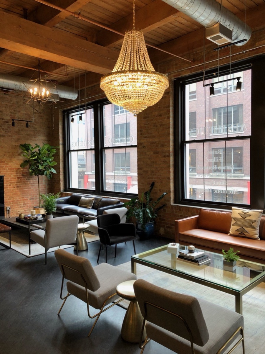 Patient lounge at the practice, with brick walls and tall windows